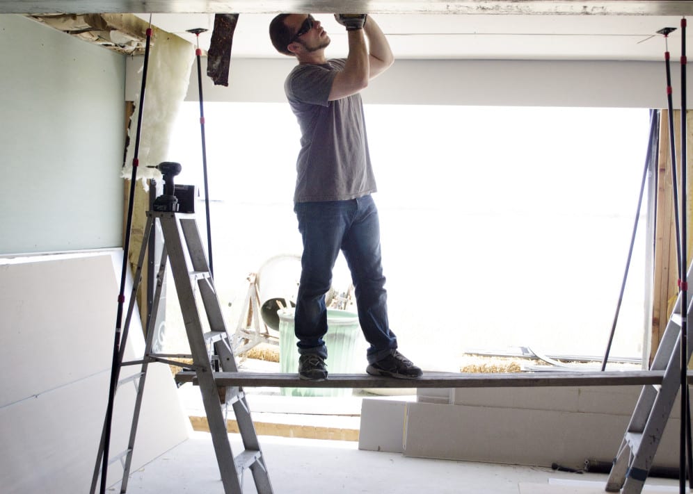 Local carpenter conducting work on ceiling